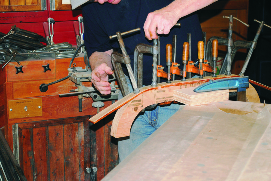 David Cumming is shown clamping coated laminations to a mold.