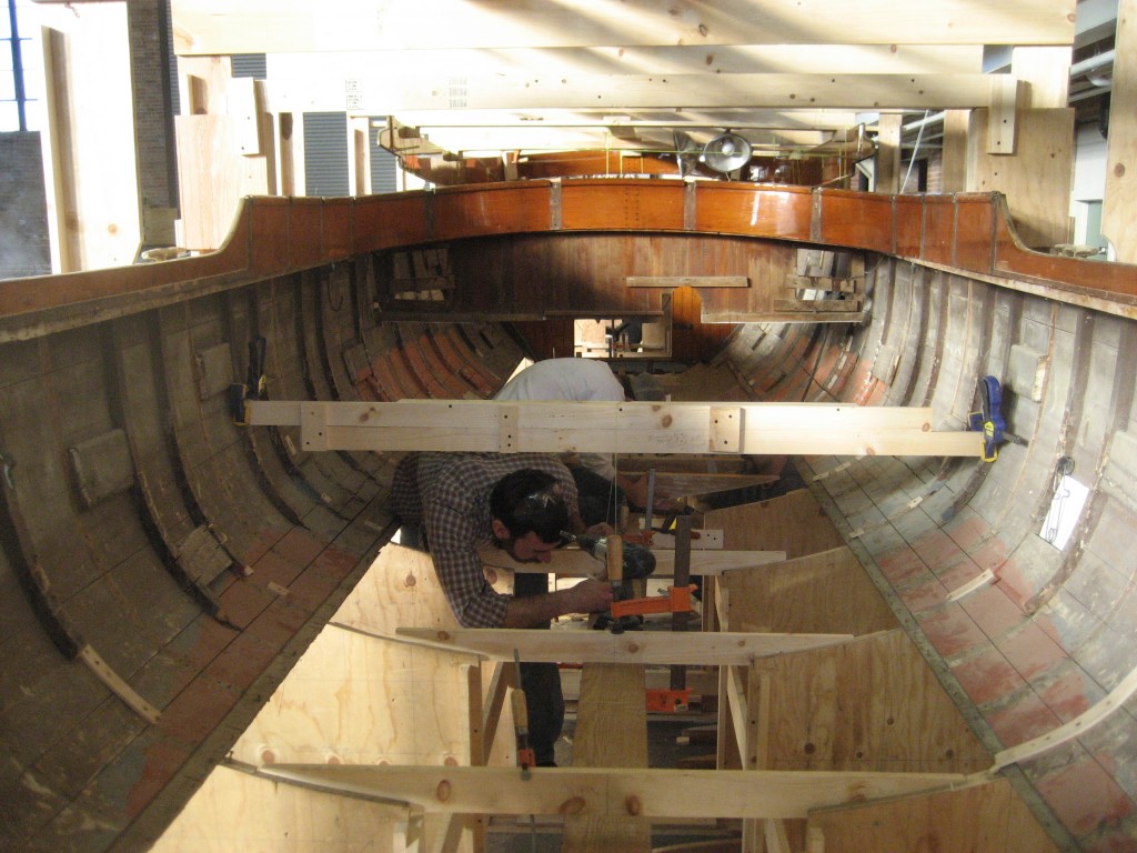 Second-year students graduate from the Beetle Cats and work in larger teams on projects that present new challenges. Here, a student works on the restoration of the 35-foot motor launch Corsair, originally launched in 1939 for yachtsman and financier J.P. Morgan. Photo by Caitlin Wood