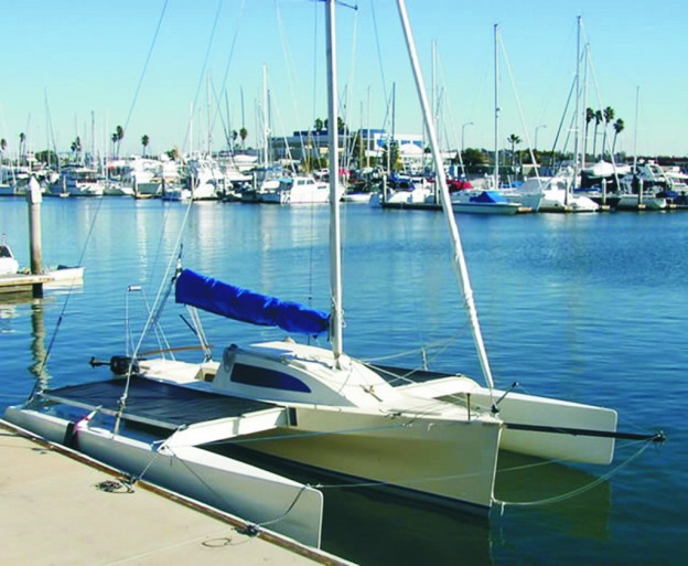 Figure 1—A completed L-7 at the dock. Multi Marine’s new 23' folding trimaran kit features manufactured hull pans. The builder attaches plywood topsides to the pans.
