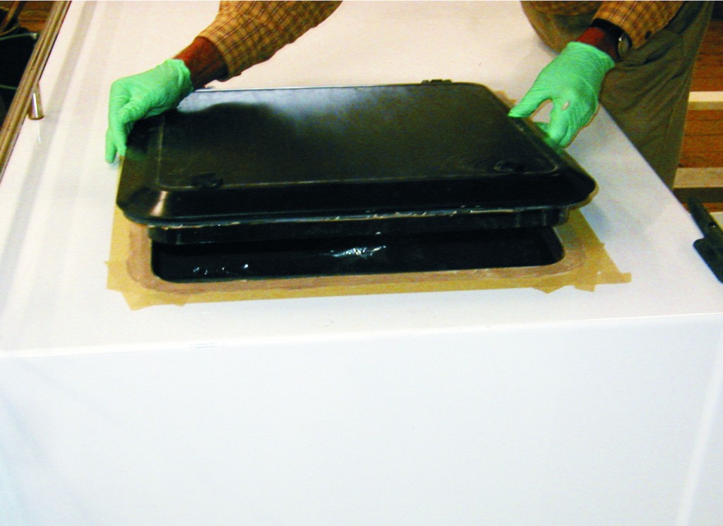 5—Position the hatch over the opening and press it into place, squeezing out any excess epoxy.