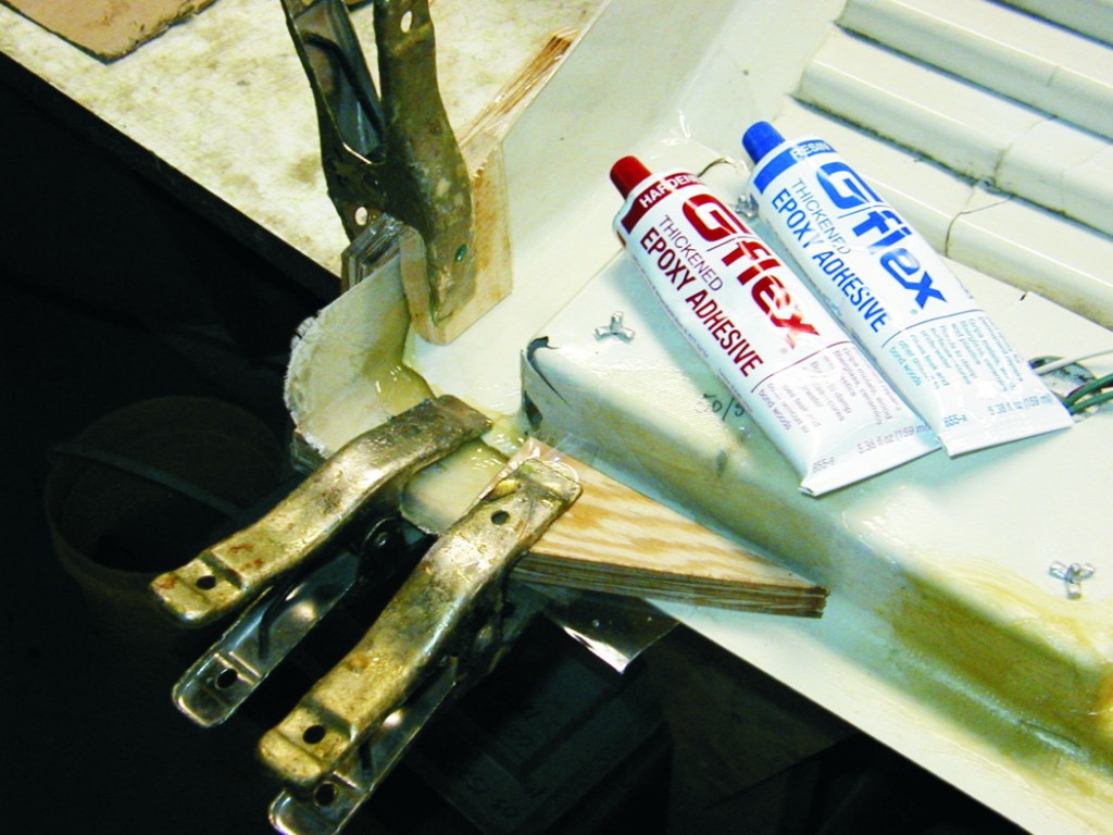 We made fiberglass laminates using similar shaped, undamaged sections of the panel as a mold. When cured, these laminates were trimmed to the shape of the missing piece and glued in place with G/flex 655 epoxy.