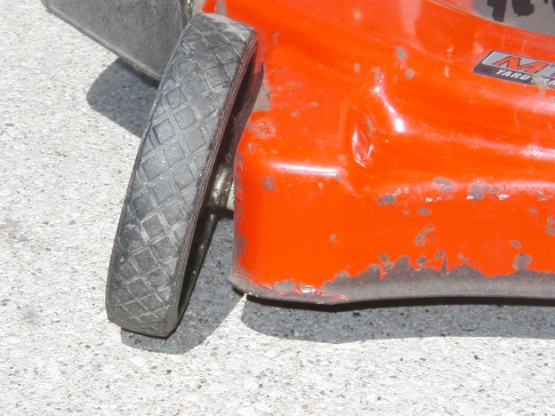 1. The metal surrounding the lawn mower wheel had corroded and was too weak to keep the wheel from flopping against the deck