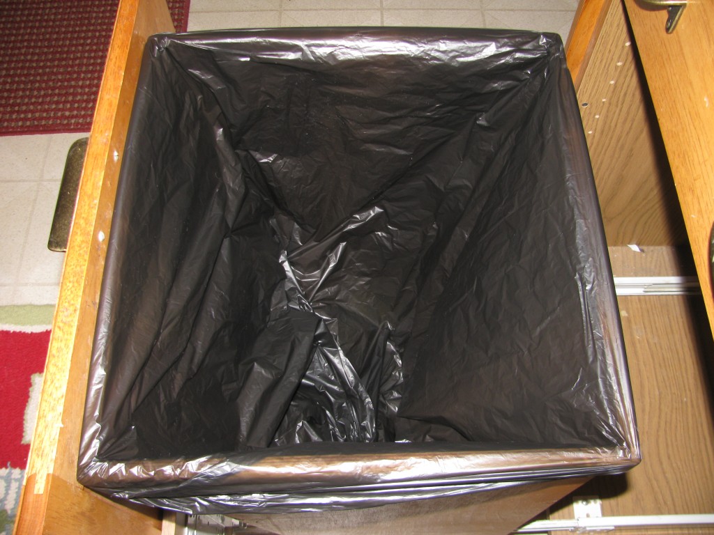 A 30-gallon trash bag fits perfectly over the 62.5" perimeter lip at the top of the basket.