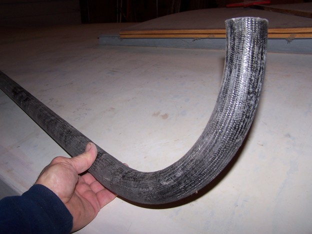 A tapered tube section joined to a curved section.