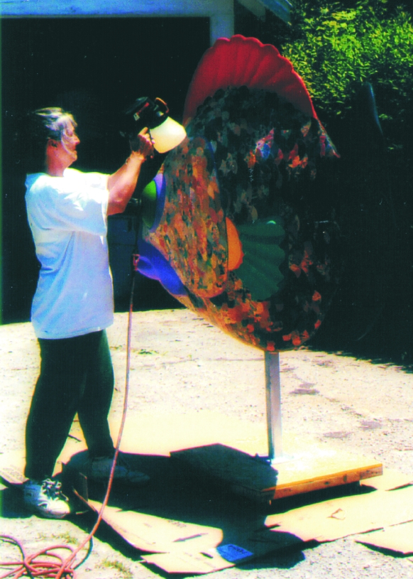 Lynch applies anti-graffiti lacquer to finish the fiberglass fish sculpture.