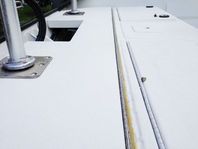 The tapered gap filled with G/Flex epoxy for aluminum hinge repair
