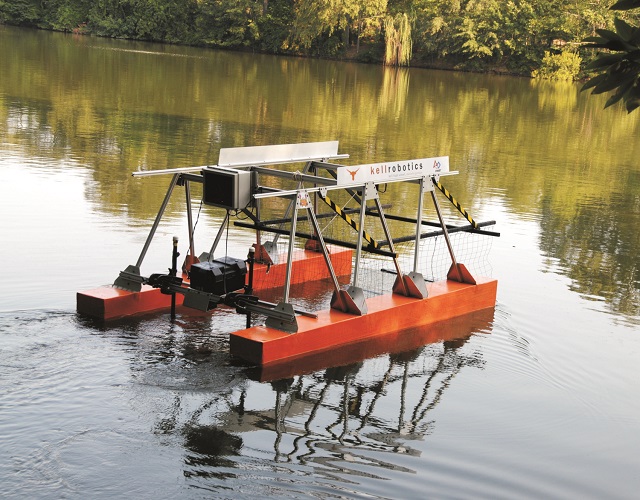 The remotely operated vehicle (ROV) scoops floating debris from the water's surface and collects it for removal.