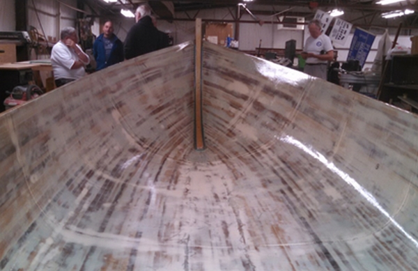 The Jericho skiff hull off the mold and covered with fiberglass. The interior was faired before the fiberglass was applied.