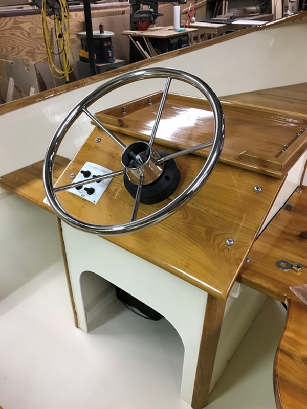 The wheel installed. The helm station is built of okoume ply with a black locust corner post and Cypress dash and shelf. The seats are cedar.