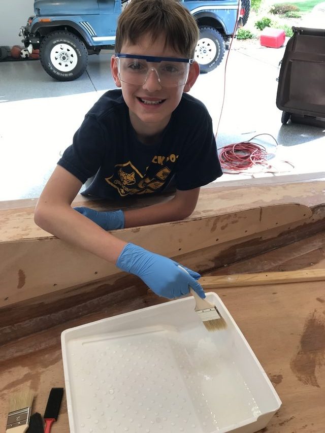 Joshua brushes a coating of neat epoxy onto his hydroplane
