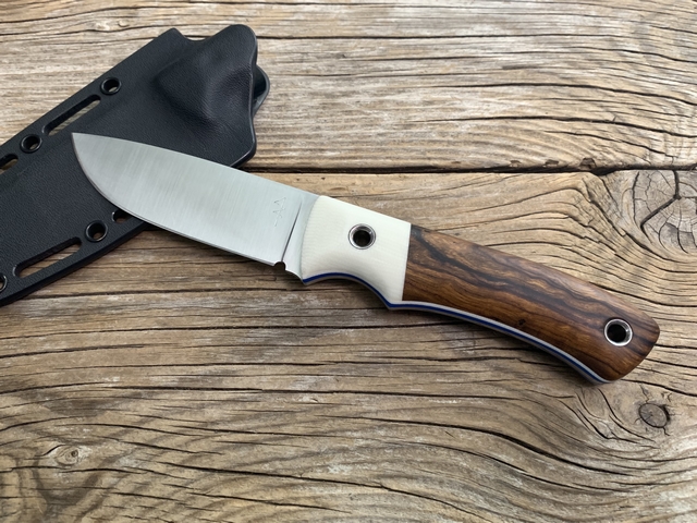 Wood handled hunting knife with blue accent