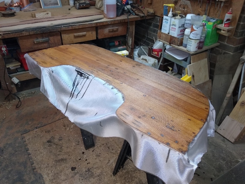 Repairing and glassing of the transom. The original transom was made up of two mahogany sections bolted onto the thin fiberglass hull’s transom.