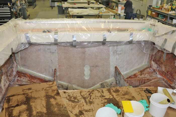 Fiberglass has been applied to the transom and tabbed onto the hull.