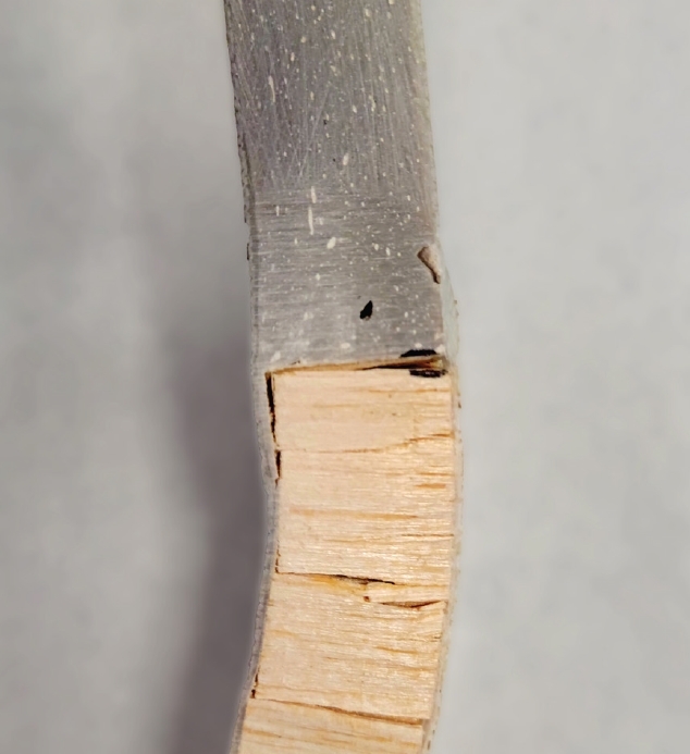 Close-up of the epoxy-filled repair. Its fiberglass and balsa core fractured right at the transition from epoxy to balsa core.