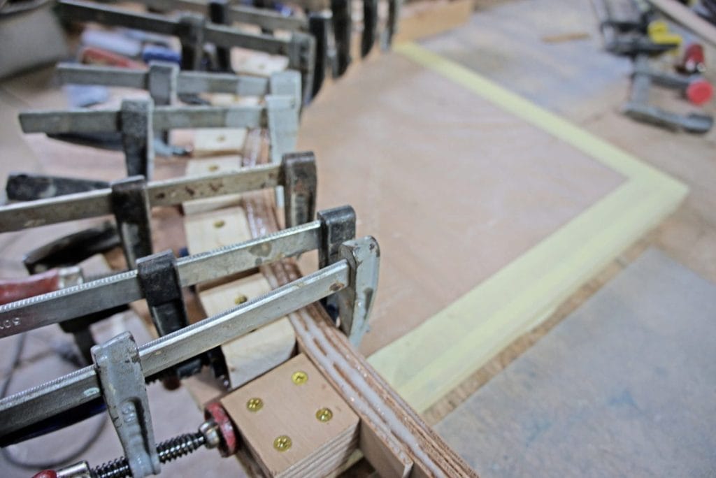 "One of the 30 corner beams being laid up in the jig." From the article, "The Woodenwidget Plystream Camper" by Robin 'Benjy' Benjamin, featured in Epoxyworks 61.