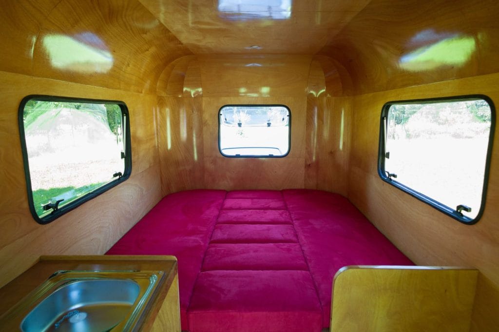 "The interior with the seat backs dropped between the bunks to make a large double 2m x 1.6m (2'6" x 5'3")." From the article, "The Woodenwidget Plystream Camper" by Robin 'Benjy' Benjamin, featured in Epoxyworks 61.